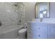 Bathroom featuring double sinks, marble countertops, and modern finishes at 10704 Flowerburst Ct, Highlands Ranch, CO 80126