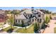 Stunning stone-clad home featuring a multi-gable roof, manicured lawn, and a welcoming stone walkway at 10704 Flowerburst Ct, Highlands Ranch, CO 80126