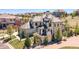 An aerial view showcasing the home's landscaping, roof, stone exterior, and backyard at 10704 Flowerburst Ct, Highlands Ranch, CO 80126