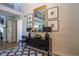 Elegant foyer featuring black and white tiled floors, statement furniture, and decorative mirrors and art at 10704 Flowerburst Ct, Highlands Ranch, CO 80126