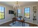 Home office with a modern desk, large windows, and built-in bookshelves at 10704 Flowerburst Ct, Highlands Ranch, CO 80126