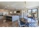 Open kitchen and breakfast nook featuring an island with seating and modern pendant lighting at 10704 Flowerburst Ct, Highlands Ranch, CO 80126