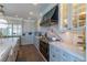 Updated kitchen featuring white cabinetry, marble countertops and backsplash, and high-end black and gold stove at 10704 Flowerburst Ct, Highlands Ranch, CO 80126