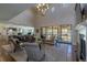 Open concept living room with fireplace and large windows providing an abundance of natural light at 10704 Flowerburst Ct, Highlands Ranch, CO 80126