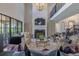Bright living room showcasing a soaring ceiling, marble fireplace, and comfortable seating at 10704 Flowerburst Ct, Highlands Ranch, CO 80126