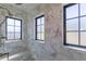 Luxurious shower with marble tiling and black-framed windows at 10704 Flowerburst Ct, Highlands Ranch, CO 80126