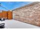 Exterior backyard space with brick wall, snow-covered ground, and privacy fence at 7729 S Cove Cir, Centennial, CO 80122