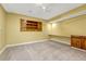 Finished basement with carpet flooring, a built in desk, and built-in shelves at 7729 S Cove Cir, Centennial, CO 80122