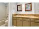 Bright bathroom features tiled shower and tub, and storage cabinets with stylish countertops and traditional fixtures at 7729 S Cove Cir, Centennial, CO 80122