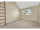 Bedroom with neutral carpet, white walls, ladder to a lofted area, and horizontal blinds at 7729 S Cove Cir, Centennial, CO 80122