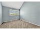 Bedroom with neutral carpet, blue walls, and horizontal blinds at 7729 S Cove Cir, Centennial, CO 80122