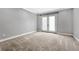 Bedroom with neutral carpet, gray walls, and a glass paneled french door at 7729 S Cove Cir, Centennial, CO 80122