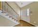 Welcoming foyer with hardwood floors, staircase, and natural light at 7729 S Cove Cir, Centennial, CO 80122