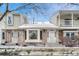 Attractive townhome exterior featuring brick facade, bay window, and inviting entrance steps with winter accents at 7729 S Cove Cir, Centennial, CO 80122