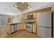 Well-equipped kitchen features modern stainless steel appliances, ample cabinetry, and sleek countertops at 7729 S Cove Cir, Centennial, CO 80122