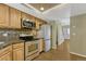 View of the kitchen with stainless steel appliances, granite countertops, and wood cabinets at 7729 S Cove Cir, Centennial, CO 80122