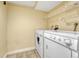 Bright laundry room with a full-size washer and dryer, plus wire shelving for organized storage solutions at 7729 S Cove Cir, Centennial, CO 80122