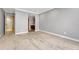 Living room featuring neutral carpet and gray walls with view into the kitchen at 7729 S Cove Cir, Centennial, CO 80122