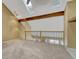 Loft with skylights, wood beam and railings, and neutral carpet at 7729 S Cove Cir, Centennial, CO 80122
