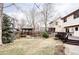 Landscaped backyard featuring a gazebo, deck, and mature trees, offering a serene and private outdoor retreat at 12699 W 84Th Dr, Arvada, CO 80005