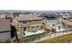 Aerial view of the backyard, patio, fenced yard and neighboring homes at 9334 Sedalia St, Commerce City, CO 80022