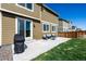 Backyard with a concrete patio, green lawn and patio furniture at 9334 Sedalia St, Commerce City, CO 80022