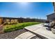 Backyard with green lawn, patio and lounge seating at 9334 Sedalia St, Commerce City, CO 80022