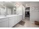 Bathroom featuring double sinks, white cabinets, and tile floor at 9334 Sedalia St, Commerce City, CO 80022