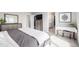 Bedroom with neutral colors, carpet, and access to the bathroom at 9334 Sedalia St, Commerce City, CO 80022