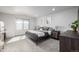 Bedroom features a black iron bed frame and neutral walls and carpeting at 9334 Sedalia St, Commerce City, CO 80022