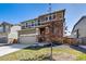Two-story home with stone accents, a well-maintained front lawn, and a driveway at 9334 Sedalia St, Commerce City, CO 80022
