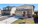 Two story home with two car garage and decorative stone exterior at 9334 Sedalia St, Commerce City, CO 80022