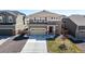 Home features a two-car garage and tasteful stone accents at 9334 Sedalia St, Commerce City, CO 80022