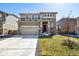 Charming two-story home with stone accents, a two-car garage, and a well-maintained front lawn at 9334 Sedalia St, Commerce City, CO 80022