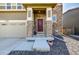 Close-up of the inviting front entrance with stone columns at 9334 Sedalia St, Commerce City, CO 80022