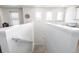 Bright upper hallway featuring stairwell leading to a functional desk and workspace area at 9334 Sedalia St, Commerce City, CO 80022