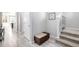 Hallway featuring a storage bench and staircase, seamlessly connecting different levels of the home at 9334 Sedalia St, Commerce City, CO 80022