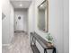 A clean hallway with modern table decor and a front door creating a welcoming ambiance at 9334 Sedalia St, Commerce City, CO 80022