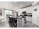 Bright, modern kitchen with stainless steel appliances, a large island, and barstool seating at 9334 Sedalia St, Commerce City, CO 80022
