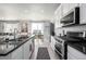 Modern kitchen featuring stainless steel appliances and an island with a sink at 9334 Sedalia St, Commerce City, CO 80022