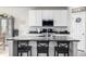 Kitchen island with a dark countertop and three barstools at 9334 Sedalia St, Commerce City, CO 80022