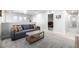 Comfortable living area with neutral walls, carpeting, and a gray sofa at 9334 Sedalia St, Commerce City, CO 80022