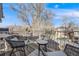 View from the balcony with outdoor seating, a table, and a residential street view at 2047 S Franklin St, Denver, CO 80210