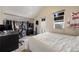 Well-lit bedroom with a walk-in closet, a white bed, and a doorway leading to the balcony at 2047 S Franklin St, Denver, CO 80210