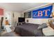 Bedroom with a large bed, TV, and colorful decor on the wall at 2047 S Franklin St, Denver, CO 80210