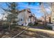Attractive home featuring a cozy balcony, awnings, and mature trees in a serene neighborhood setting at 2047 S Franklin St, Denver, CO 80210