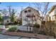 Street view of inviting home with white picket fence, trimmed shrubs, and manicured lawn at 2047 S Franklin St, Denver, CO 80210