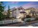 Charming home with a white picket fence, lush trees, and a cozy balcony; perfect for enjoying the outdoors at 2047 S Franklin St, Denver, CO 80210