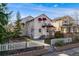Charming home with a white picket fence, lush trees, and a cozy balcony; perfect for enjoying the outdoors at 2047 S Franklin St, Denver, CO 80210