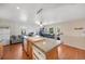 Kitchen featuring a large island with seating, a full-size refrigerator, and wood-look flooring at 2047 S Franklin St, Denver, CO 80210